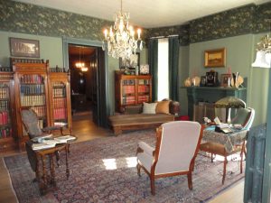 An interior room, decorated in the old fashioned style of stately Denver mansions