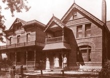 Photo shows the façade of the old Childrens Hospital in Denver. It’s two stories and resembles a family home, with a porch and balcony out front.